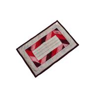Table mat with patch work in a rectangular shape.